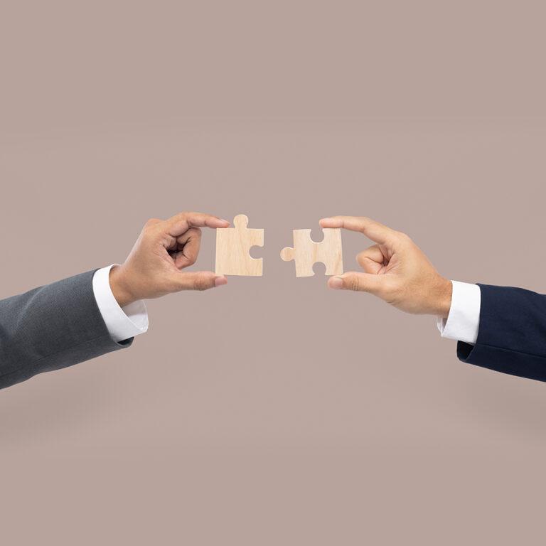 Hands holding puzzle business problem solving concept